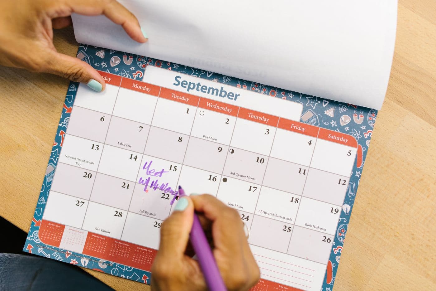 Calendar on a roofer’s office wall with storm season marked from October to March