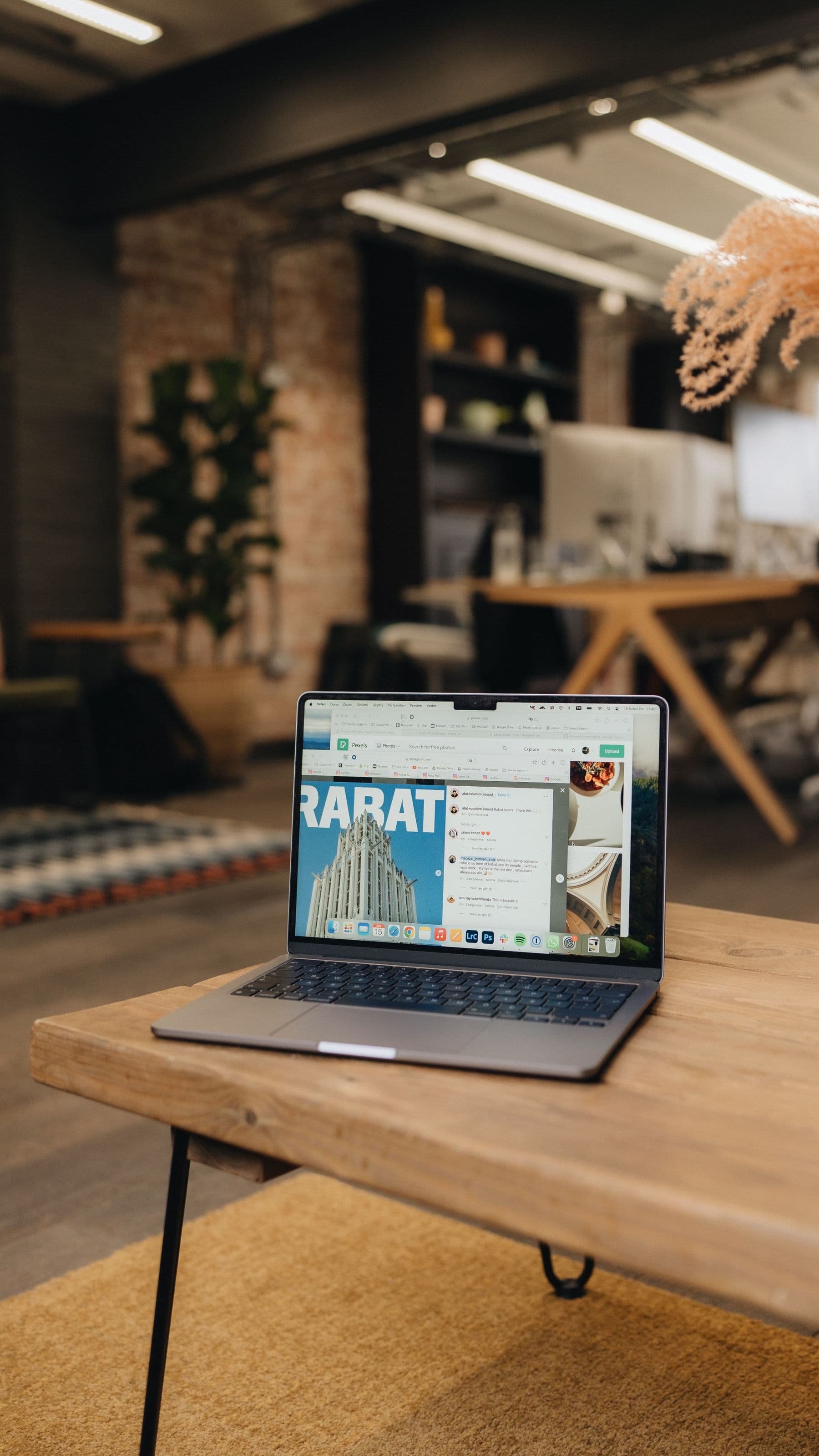 Laptop on a table in a London office showing a website