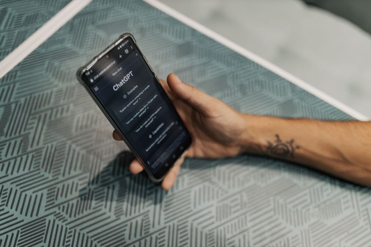 Homeowner asking an AI assistant on a phone to recommend a local roofer