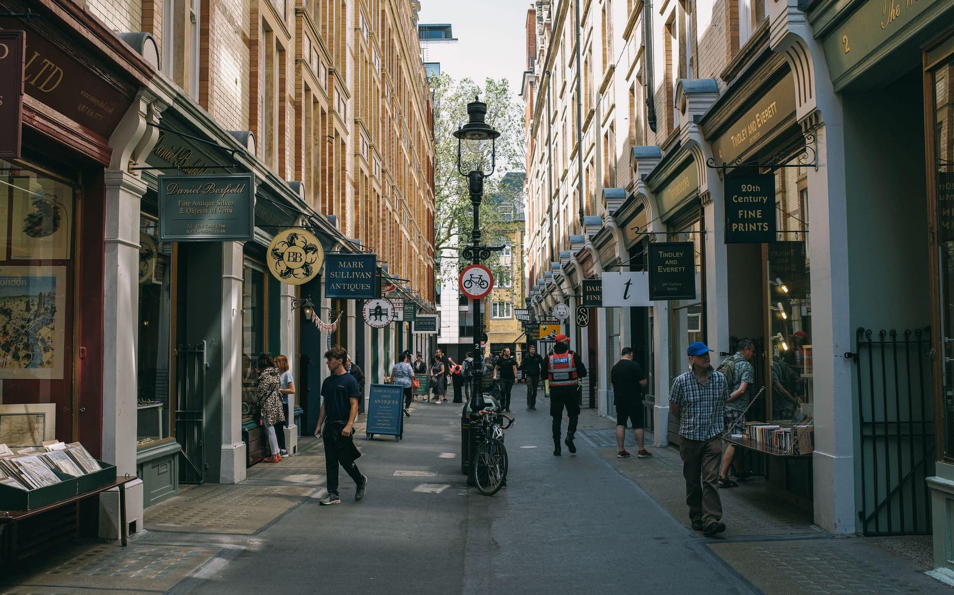 Woman reading a local newspaper on a London street